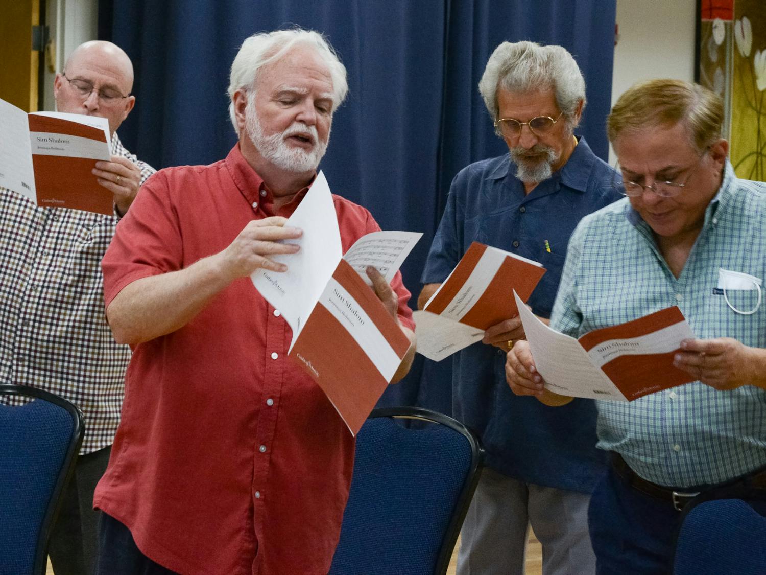 Willard Kesling (second from left), a UF choral professor and music director and conductor for the ShabbaTones Jewish choir, leads the baritone section of the ShabbaTones in a choir practice on Wednesday, July 28, 2021. "I will not let art, not let culture die," Kesling said, before the group began their first in-person choir practice since the COVID-19 pandemic halted performances in early 2020.