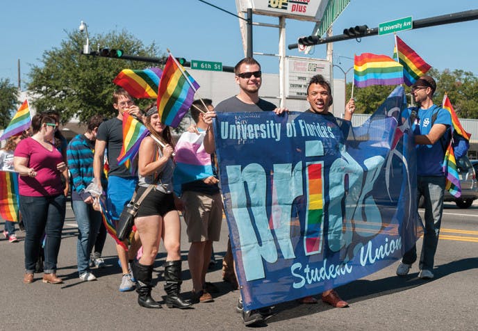Members of the Pride Student Union at UF march in the Pride parade Saturday afternoon. The event started at Eighth Street and spanned all the way to Bo Diddley Community Plaza.