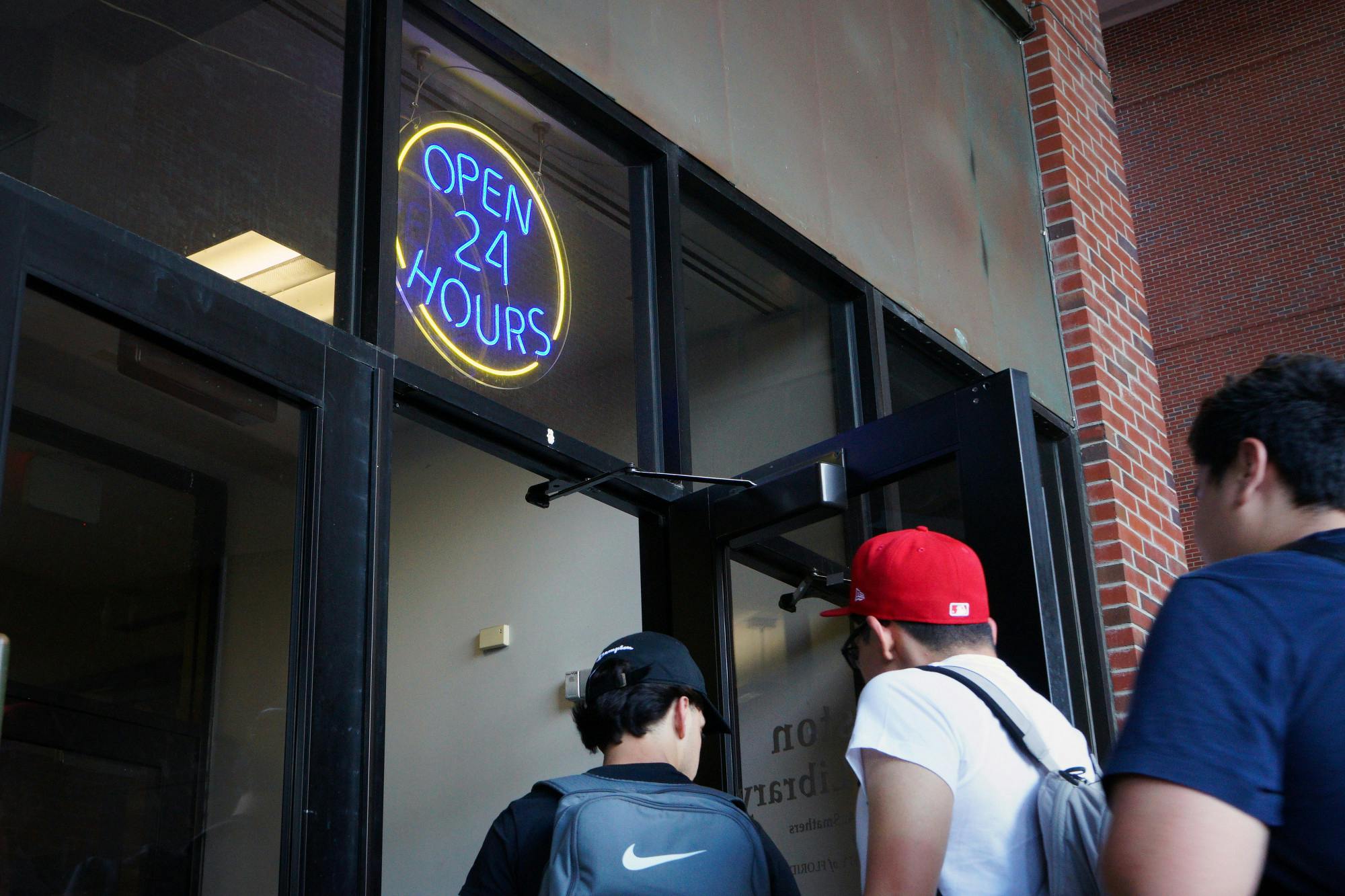 A new sign outside the entrance of Marston Science Library advertising its 24-hour schedule is seen Sunday, March 26, 2023.