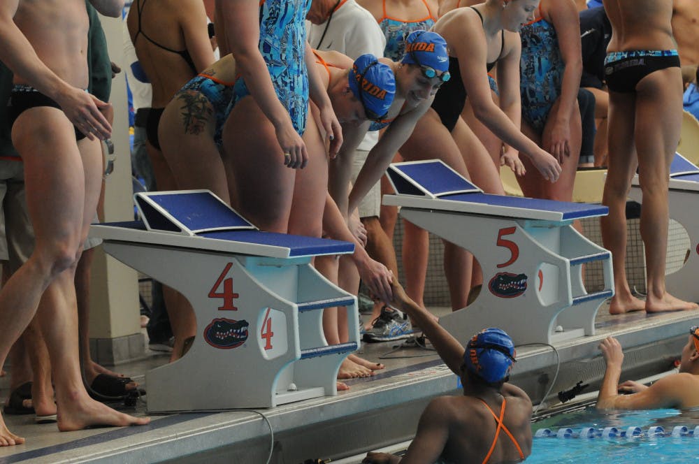 <p>Teammates celebrate with Natalie Hinds after her leg of the 400 meter freestyle relay during Florida’s meet against Auburn on Jan. 23, 2016, in the O’Connell Center.</p>