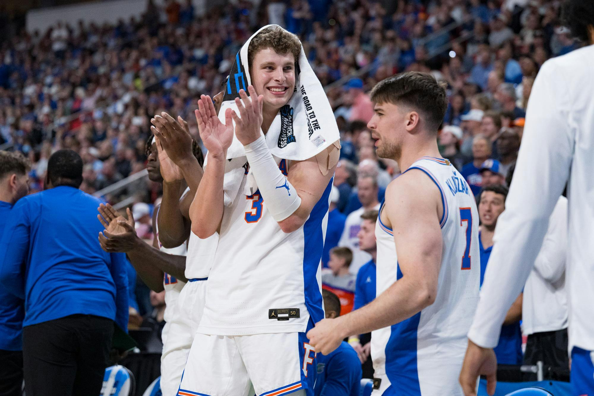 Florida Gators center Micah Handlogten (3) and guard Urban Klavzar (7) applaud their teammates during a basketball game against UConn in the second round of the NCAA Tournament on Sunday, March 23, 2025, in Raleigh, N.C.