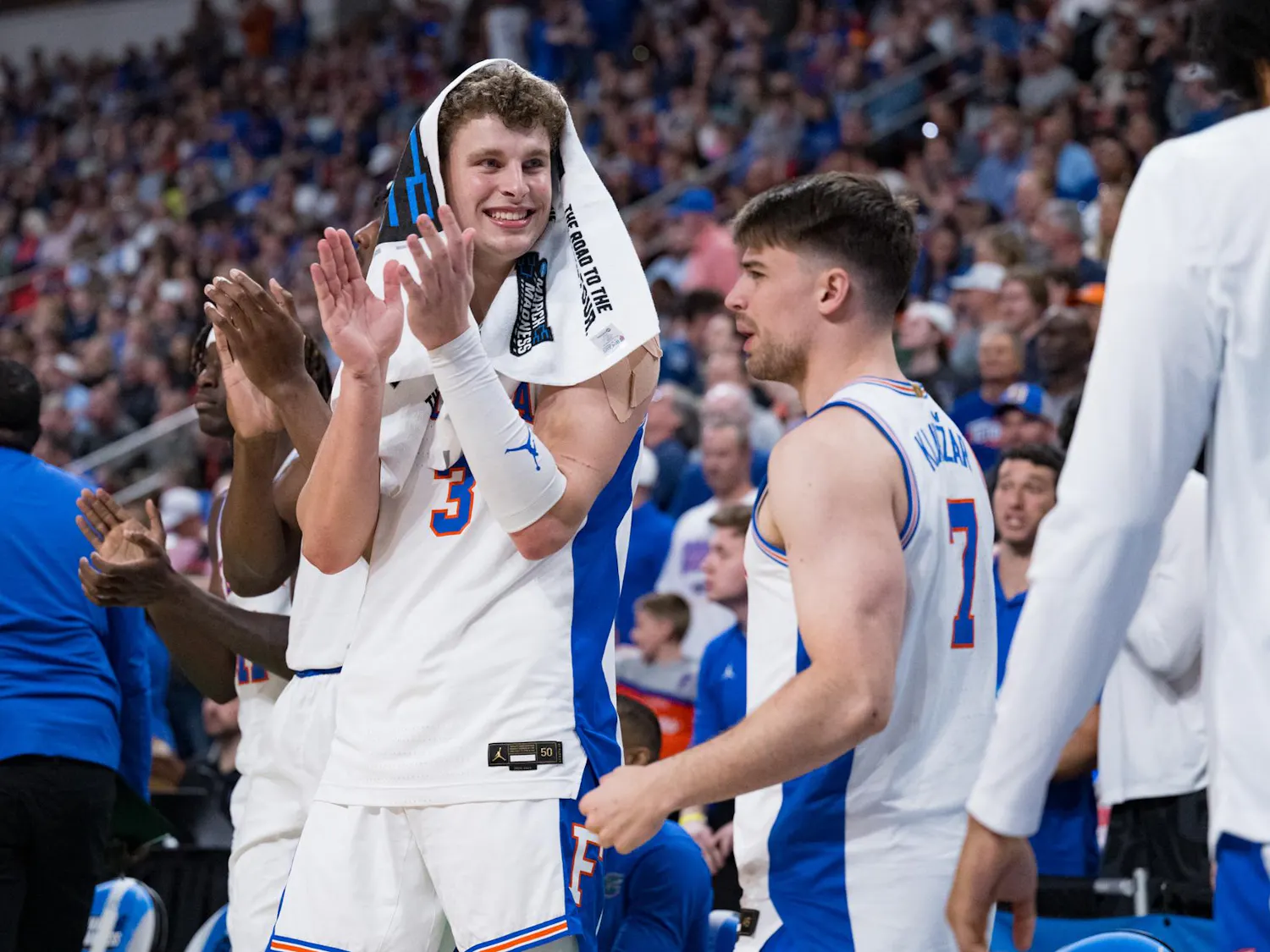 Florida Gators center Micah Handlogten (3) and guard Urban Klavzar (7) applaud their teammates during a basketball game against UConn in the second round of the NCAA Tournament on Sunday, March 23, 2025, in Raleigh, N.C.