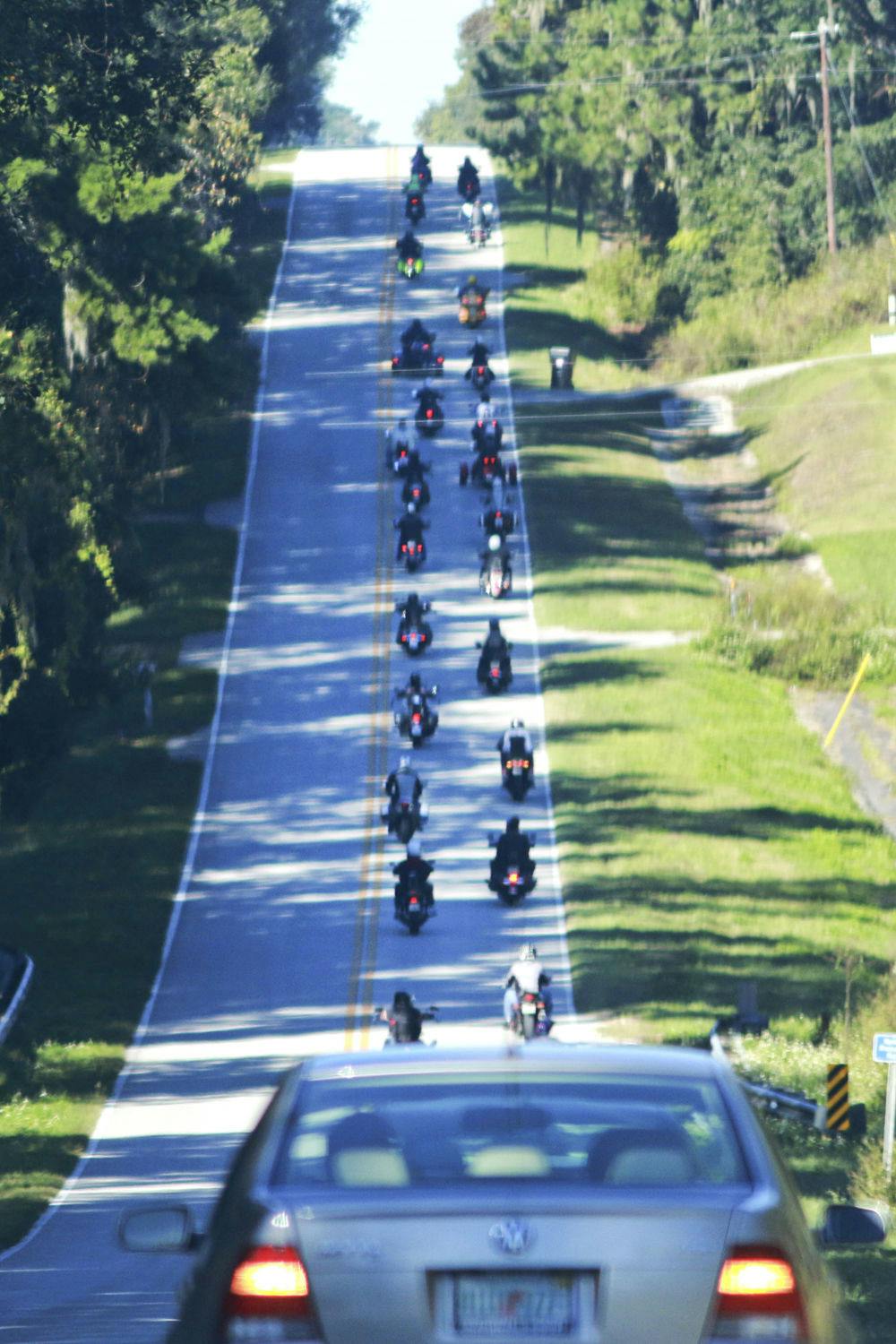 A memorial procession of about 40 motorcycles and a handful of cars head to Fort White for Marion Rose Harvey's service Friday.