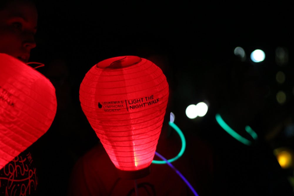 A red lantern, representing supporters of those who've had cancer of the blood, lights up the north lawn of Ben Hill Griffin Stadium during the Light the Night walk on Wednesday night.