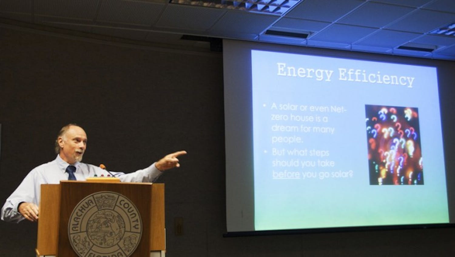 Kevin Veach, owner of Green Energy Options, chooses a member of the audience to answer on the sexiness of energy efficiency at a solar energy and efficiency workshop at the Alachua County Administration building Saturday morning.