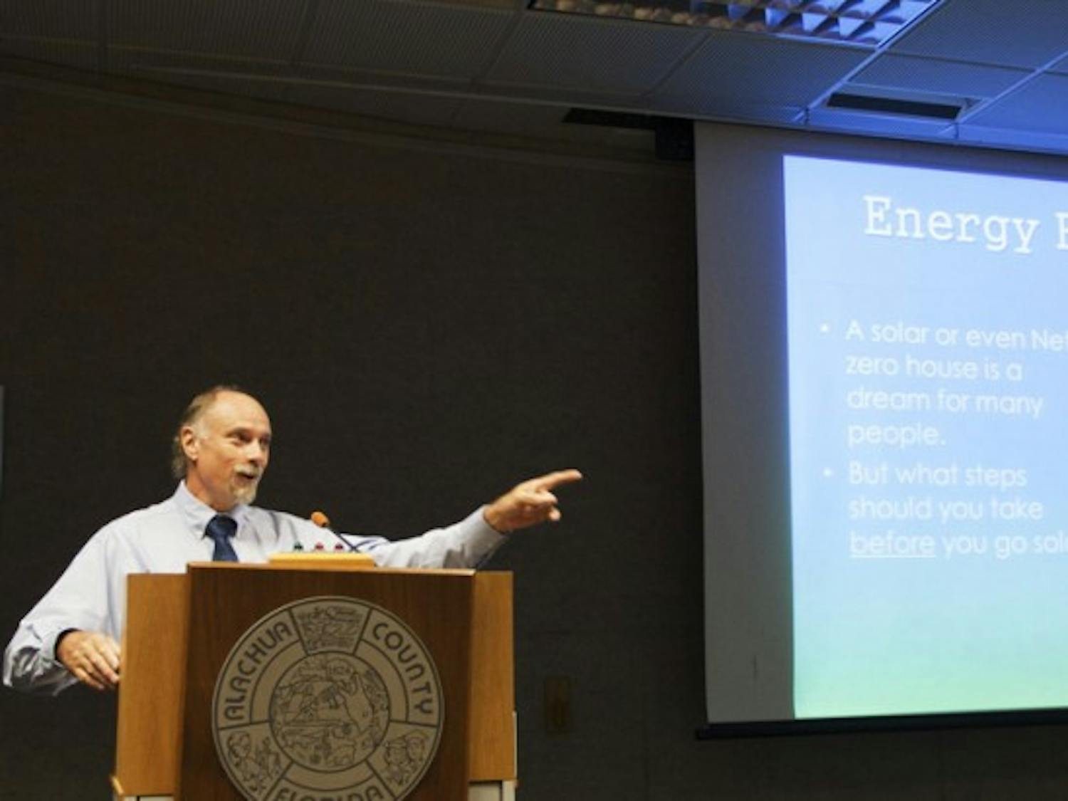 Kevin Veach, owner of Green Energy Options, chooses a member of the audience to answer on the sexiness of energy efficiency at a solar energy and efficiency workshop at the Alachua County Administration building Saturday morning.