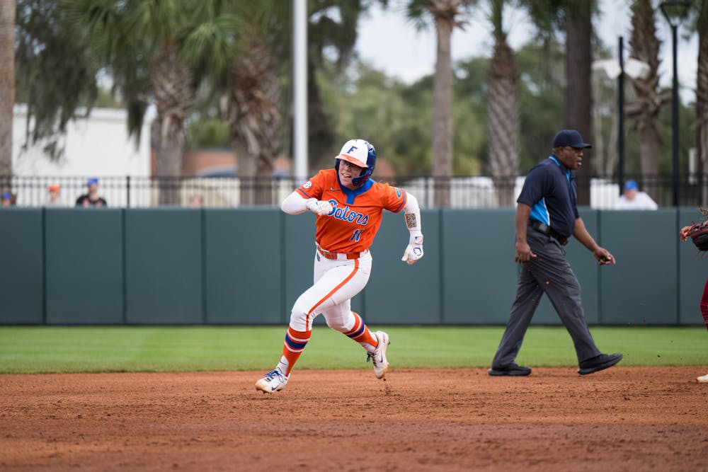 Florida Gators infielder Mia Williams (11) runs to third in a softball game against Boston College in Gainesville, Fla., on Saturday, Feb. 15, 2025.