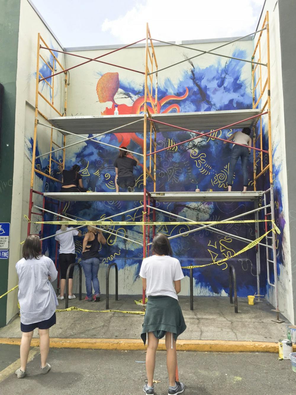 <p>Students enrolled in the UF College of Arts class, Site Specific Painting, collaborated with 352Walls to paint a mural at the Sun Center in downtown Gainesville, located at 101 SE Second Place.</p>