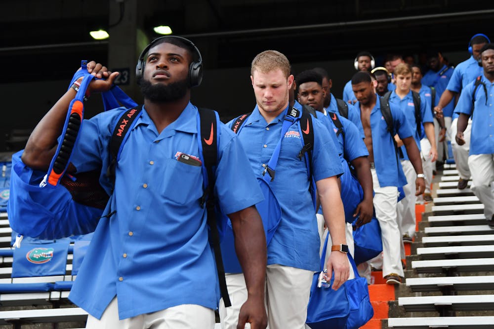 <p><span>From left: Jarrad Davis, Steven Stipe and the rest of Florida's football team descend into The Swamp prior to UF's 32-0 win over North Texas on Sept. 17, 2016.</span></p>