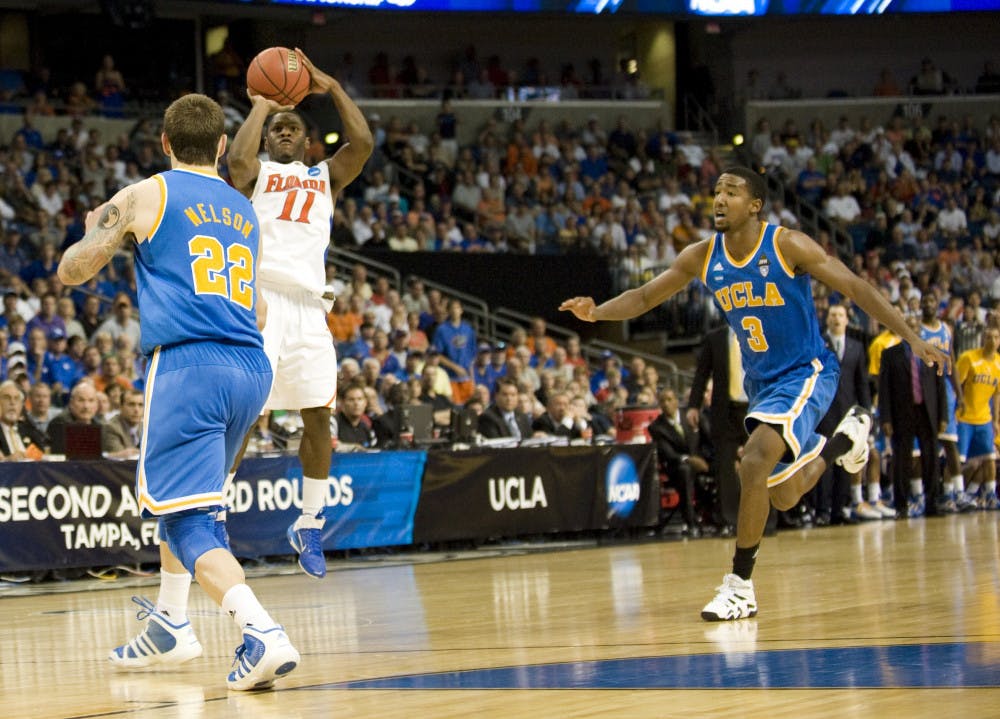 Gator guard Erving Walker sinks a three late in Florida's 73-65 win over UCLA in the St. Pete Times Forum in Tampa on Saturday. Walker racked up 21 points and propelled UF into the Sweet 16.