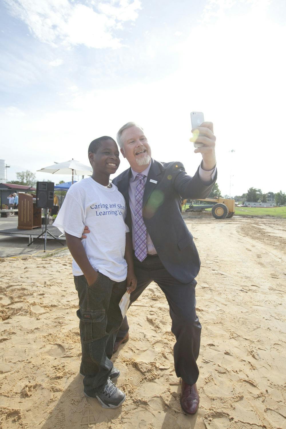 Jacques Danieles (left), an 11-year-old Caring and Sharing Learning school student, takes a selfie with Mayor Ed Braddy at Depot Park. In one year, Depot Park opens with a children's area that includes a splash pad and a playground.