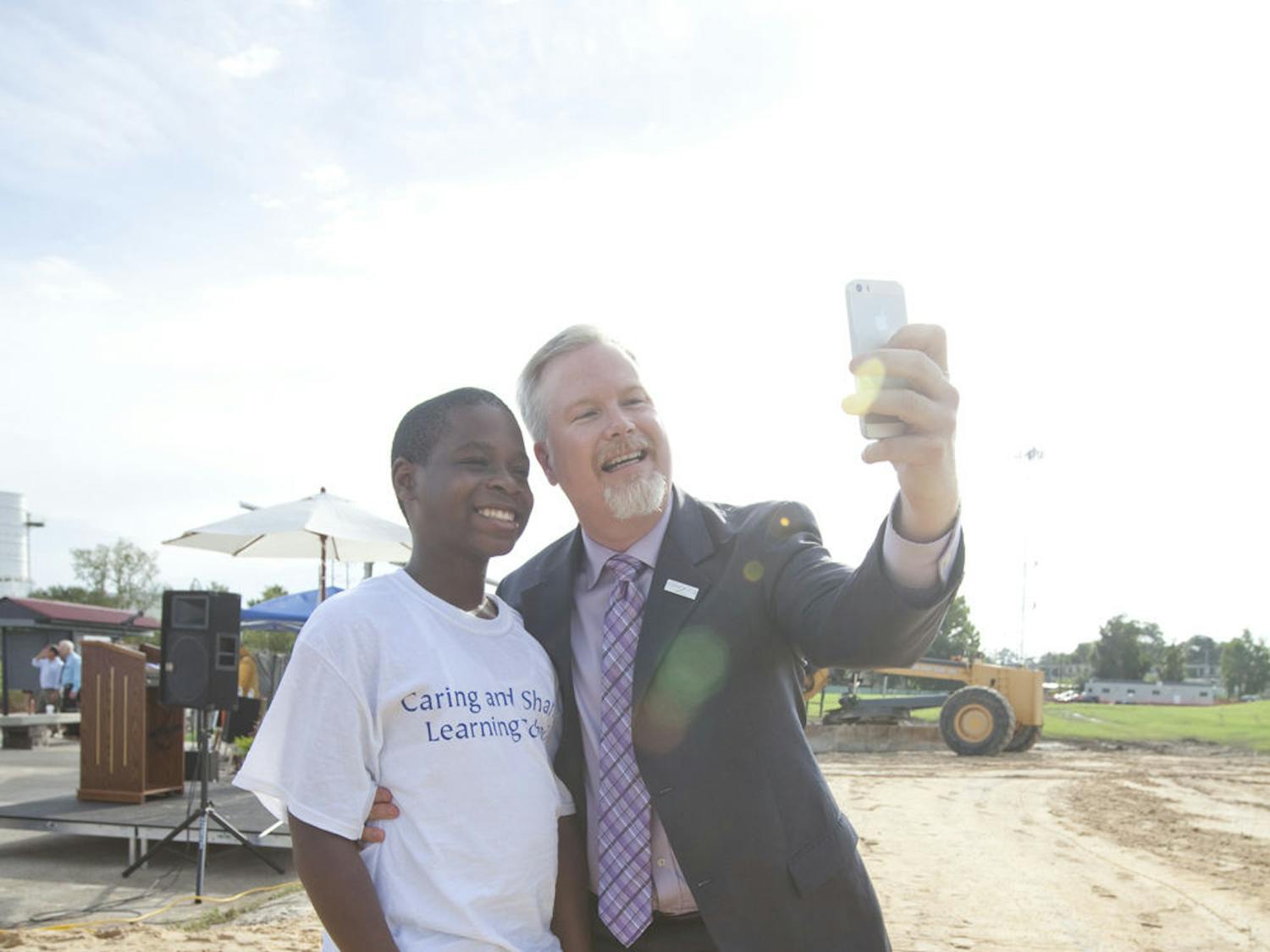 Jacques Danieles (left), an 11-year-old Caring and Sharing Learning school student, takes a selfie with Mayor Ed Braddy at Depot Park. In one year, Depot Park opens with a children's area that includes a splash pad and a playground.