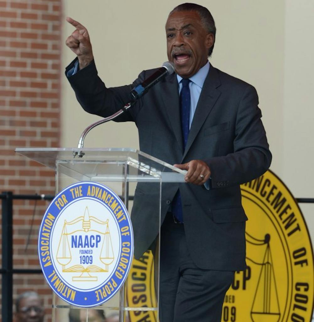 <p>The Rev. Al Sharpton speaks to demonstrators at the Sanford Police Department on Saturday afternoon. Sharpton and the Rev. Jesse Jackson led the march to the police department Saturday morning.</p>