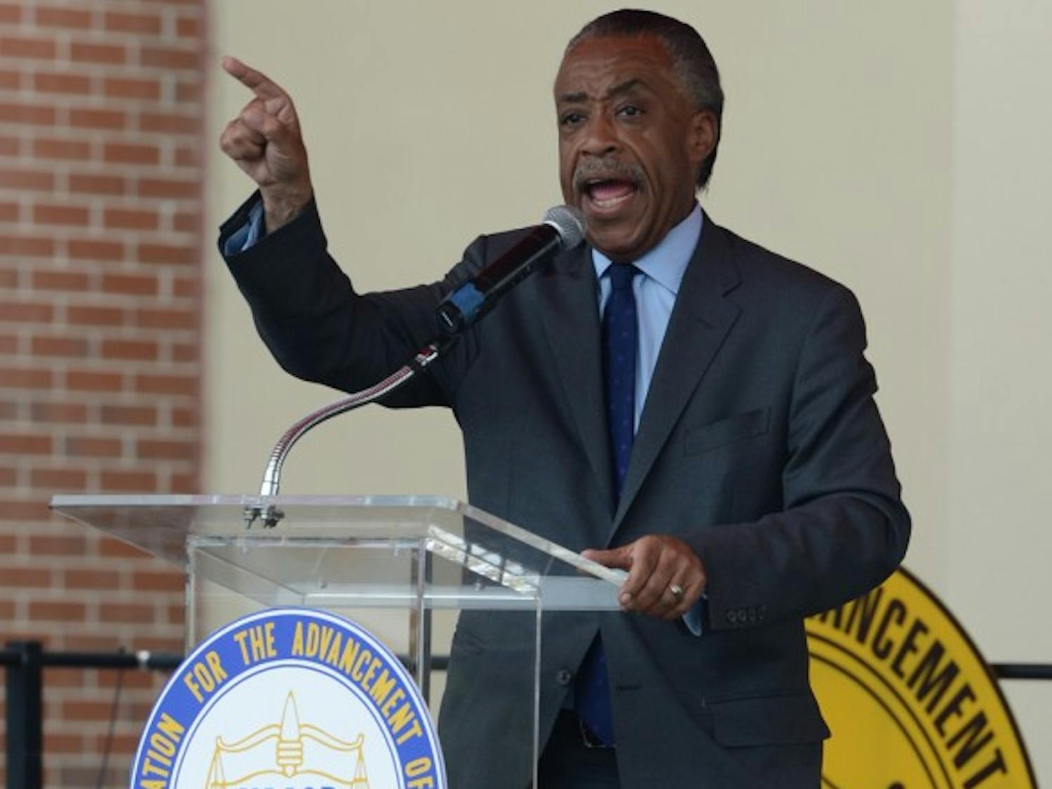 The Rev. Al Sharpton speaks to demonstrators at the Sanford Police Department on Saturday afternoon. Sharpton and the Rev. Jesse Jackson led the march to the police department Saturday morning.
