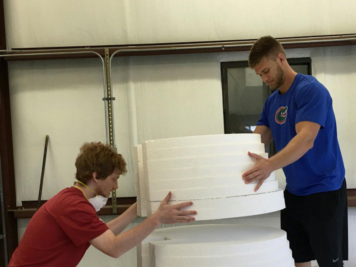 Captain and co-founder of Gatorloop Taylor Waber, left, and another member of the engineering club start to make the mold for the pod that will be put on a track this summer for SpaceX’s Hyperloop competition.