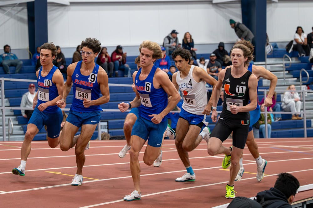 Florida distance runner Riley Smith (left) races in the men’s 1000 during the Jimmy Carnes Invitational in Gainesville, Fla., Friday, Jan. 16, 2026.