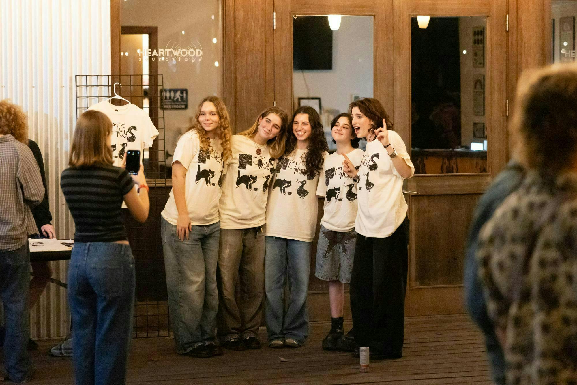 Fans of The Nancys pose in the band's merch at Heartwood Soundstage on Friday, Jan. 31, 2025. 