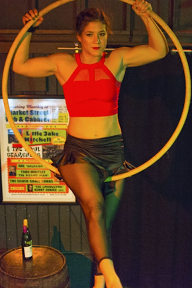 Kelly Ulmer, a 25-year-old AscenDance aerialist mental health counselor, swings from a lyra at Market Street Pub and Cabaret. Ulmer said she got bored with yoga and tried out an aerial arts class at S-Connection Aerial Arts, which started her love for the craft.
