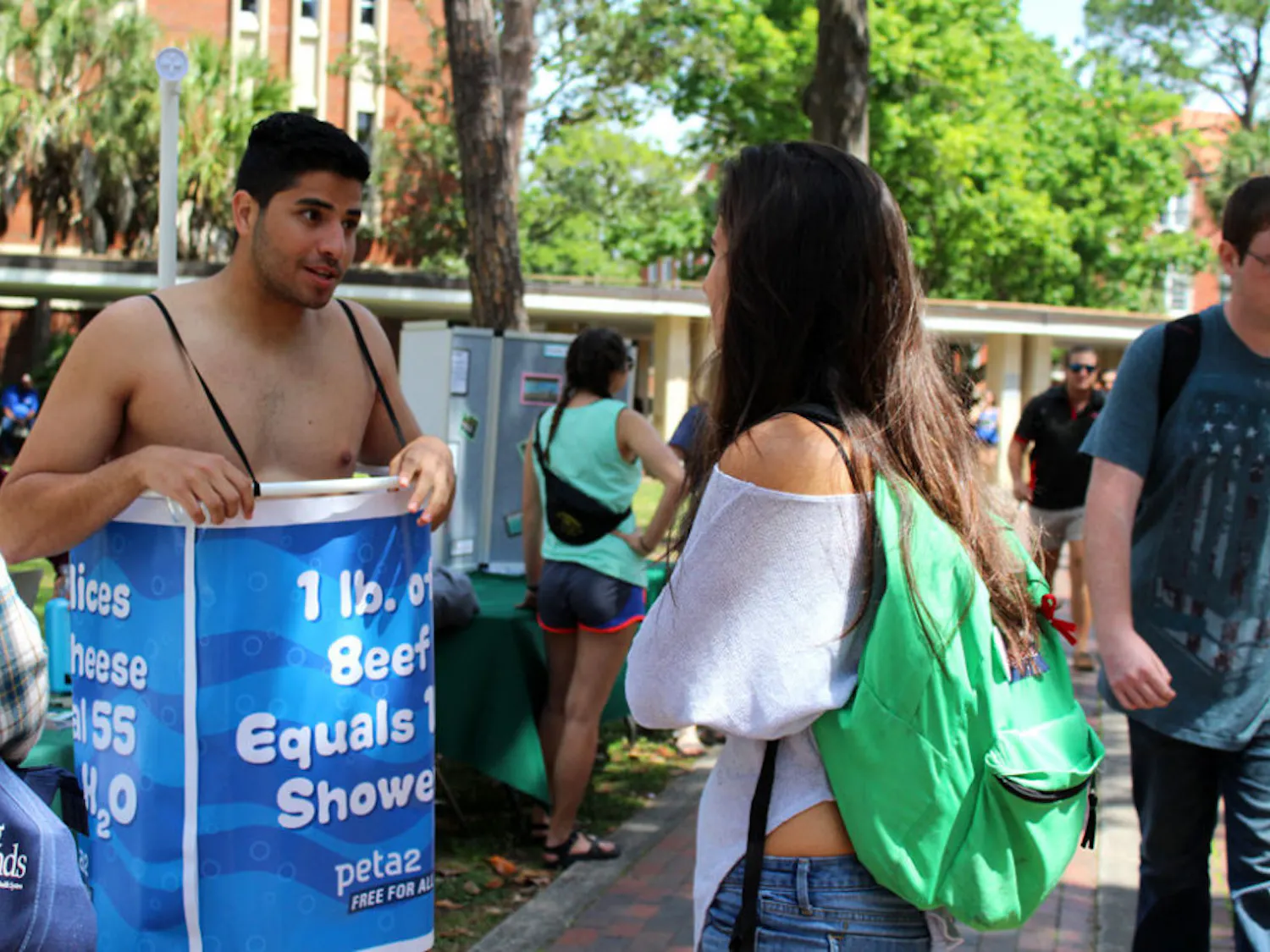 Manny Rutinel, a 21-year-old UF microbiology and cell science and economics senior, left, promotes the Student Animal Alliance by promoting veganism. Rutinel said it's easy to remember to turn off a faucet while you soap or brush your teeth, but animal agriculture accounts for more environmental problems than any other sector of the environment. "In order to go green, you have to eat green," he said.