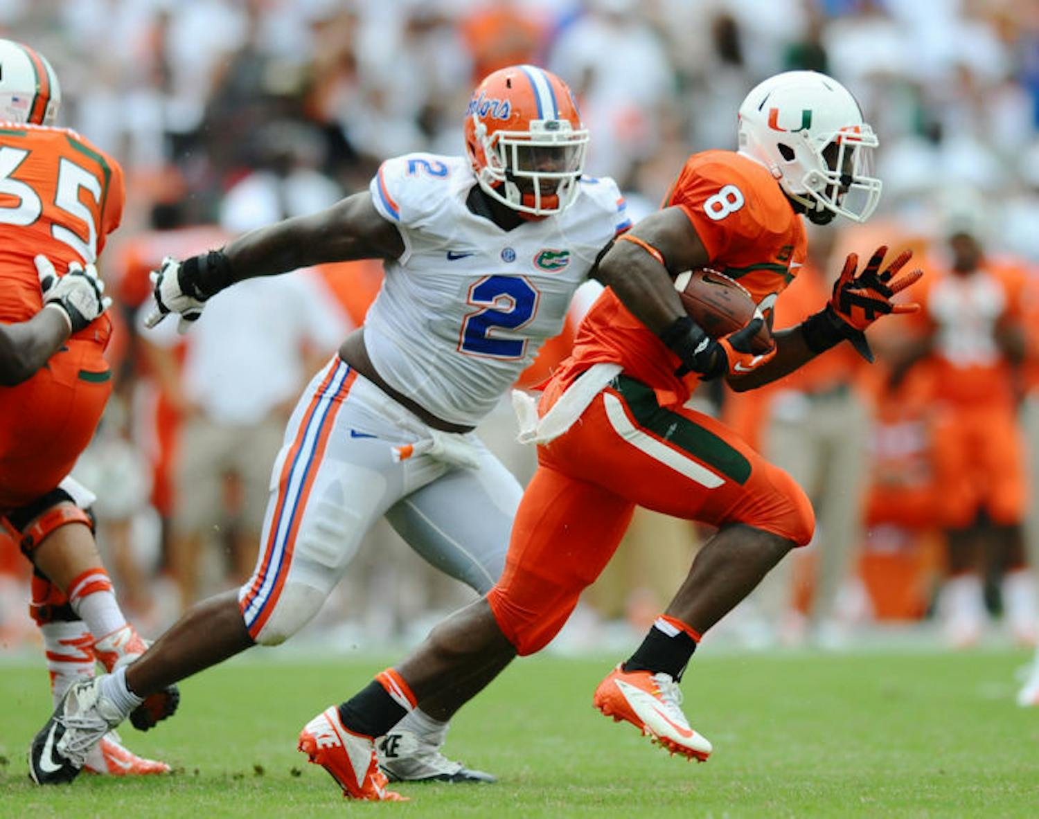 Florida senior defensive tackle Dominique Easley (2) chases Miami running back Duke Johnson (8) during the Gators’ 21-16 loss to the Hurricanes on Sept. 7 in Sun Life Stadium. UF is No. 3 in the nation in total defense, allowing 208.5 yards per game this season.