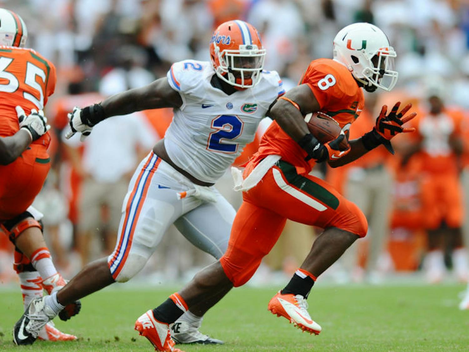 Florida senior defensive tackle Dominique Easley (2) chases Miami running back Duke Johnson (8) during the Gators’ 21-16 loss to the Hurricanes on Sept. 7 in Sun Life Stadium. UF is No. 3 in the nation in total defense, allowing 208.5 yards per game this season.