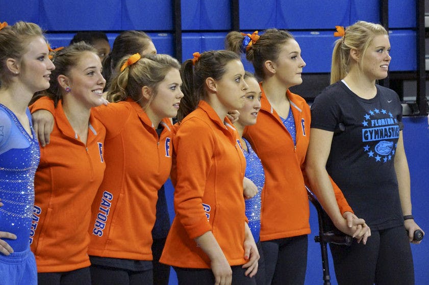 Jamie Shisler (far right) watches on during Florida's win against Georgia on Jan. 30 in the O'Connell Center.