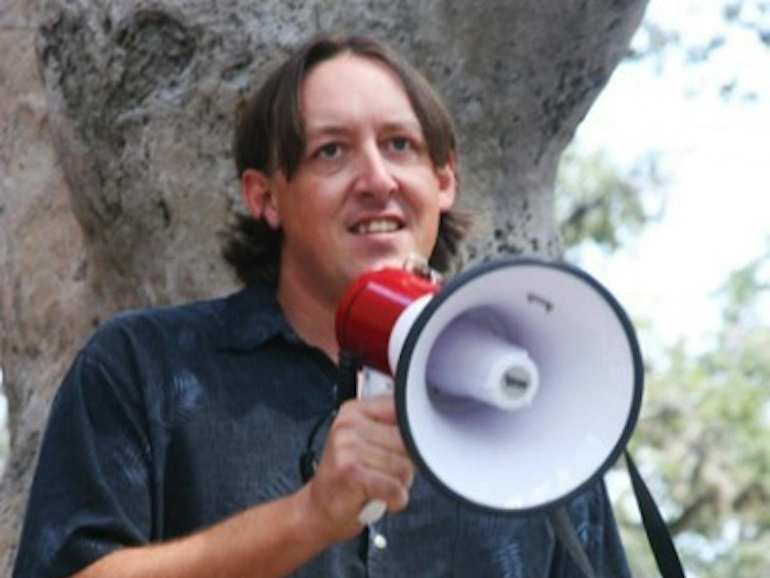 James Ingle, a City Commission candidate for the at-large 1 seat, speaks to student activists at a protest on campus Friday.