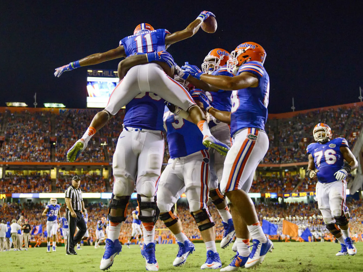 Demarcus Robinson (11) celebrates with teammates after scoring a touchdown in Florida's 36-30 triple-overtime win against Kentucky on Saturday at Ben Hill Griffin Stadium.