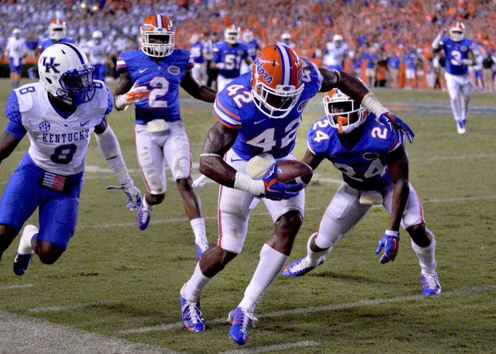 Florida safety Keanu Neal (42) intercepts a pass intended for Kentucky wide receiver Javess Blue (8) during the Gators' 36-30 triple-overtime win against the Wildcats on Saturday at Ben Hill Griffin Stadium.