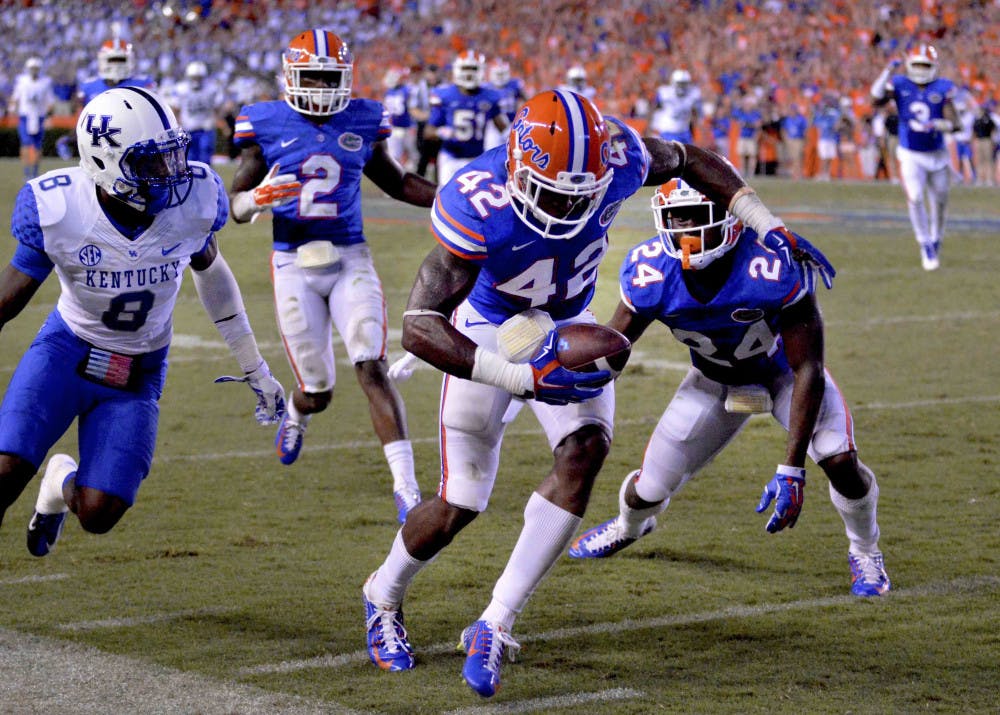 <p>Florida safety Keanu Neal (42) intercepts a pass intended for Kentucky wide receiver Javess Blue (8) during the Gators' 36-30 triple-overtime win against the Wildcats on Saturday at Ben Hill Griffin Stadium.</p>