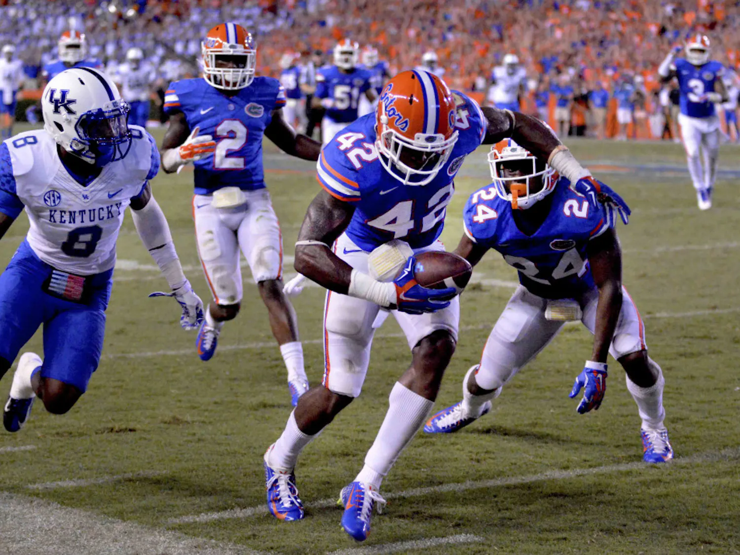 Florida safety Keanu Neal (42) intercepts a pass intended for Kentucky wide receiver Javess Blue (8) during the Gators' 36-30 triple-overtime win against the Wildcats on Saturday at Ben Hill Griffin Stadium.
