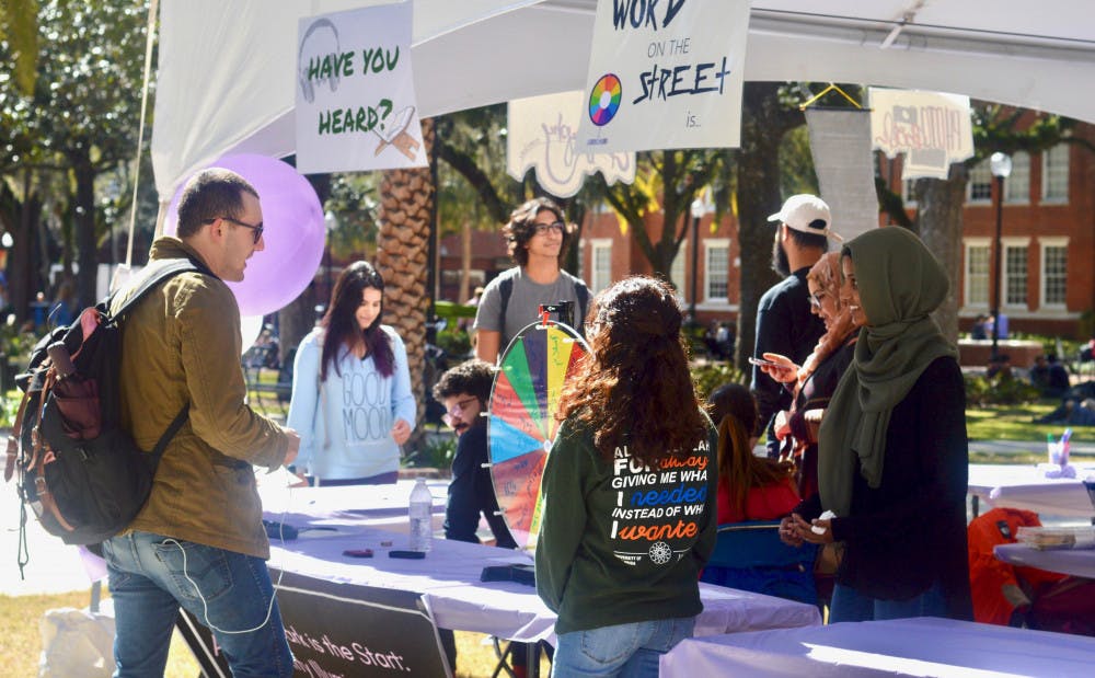 <p>Students gather in Plaza of the Americas for UF’s Islam on Campus’ Islam Fair on Monday afternoon. The event featured free calligraphy, free, henna and free food, with the goal of educating students about Islam.</p>