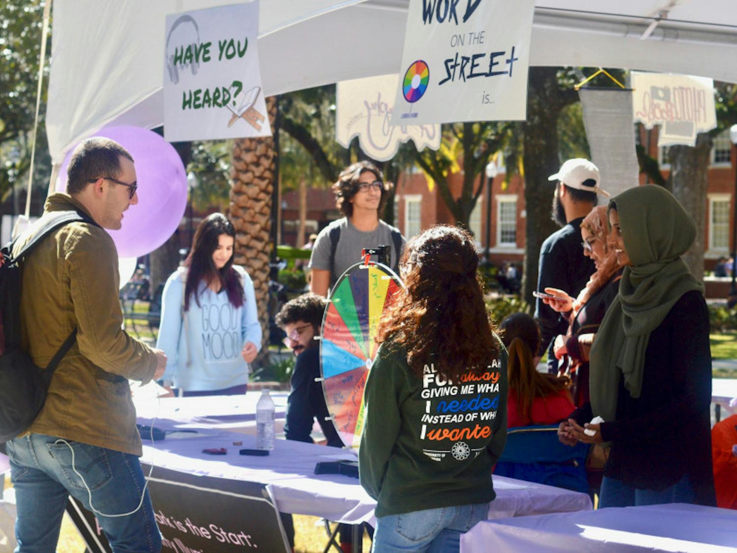 Students gather in Plaza of the Americas for UF’s Islam on Campus’ Islam Fair on Monday afternoon. The event featured free calligraphy, free, henna and free food, with the goal of educating students about Islam.