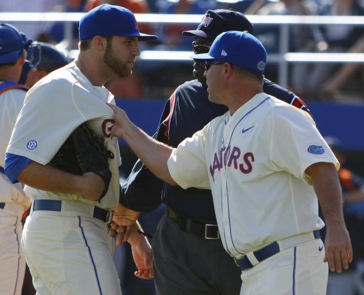 Florida manager Kevin O’Sullivan (right) tugs the jersey of pitcher Steven Rodriguez after umpire Rob Healy ejected Rodriguez from the game for throwing behind Cal State Fullerton batter Austin Kingsolver. UF lost 8-5 on Sunday.