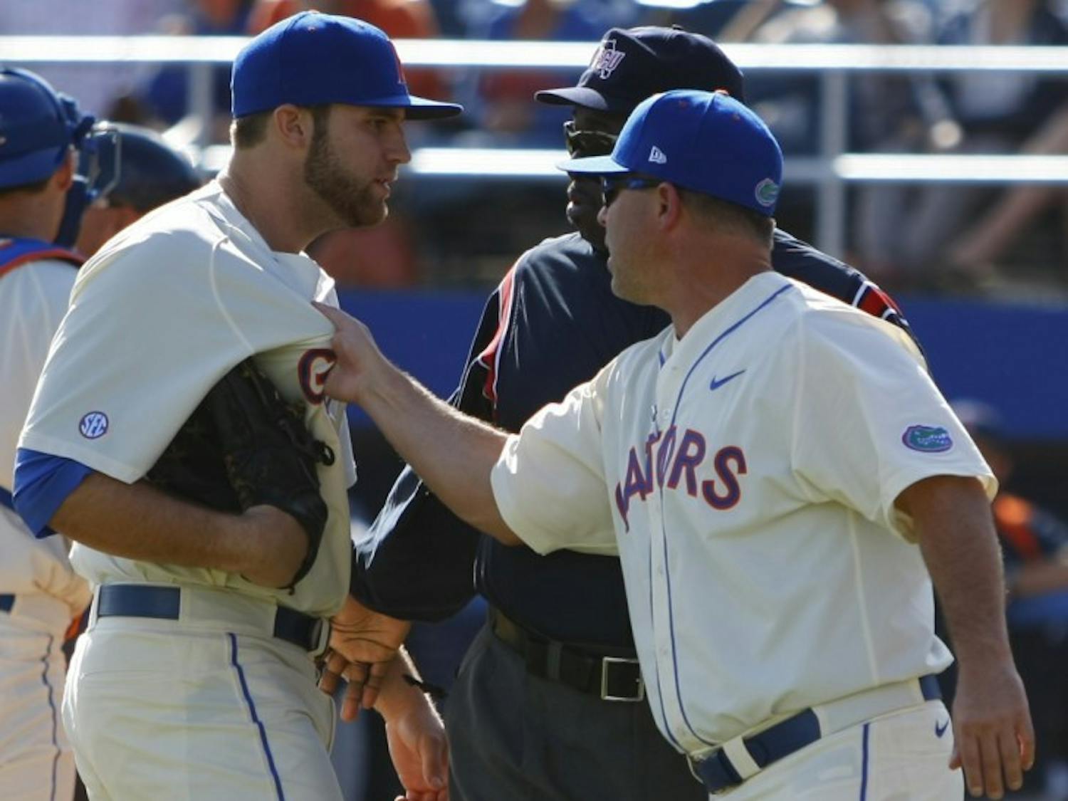 Florida manager Kevin O’Sullivan (right) tugs the jersey of pitcher Steven Rodriguez after umpire Rob Healy ejected Rodriguez from the game for throwing behind Cal State Fullerton batter Austin Kingsolver. UF lost 8-5 on Sunday.