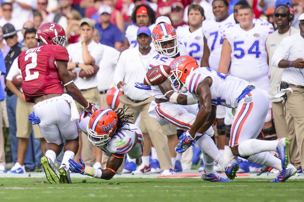<p>Neiron Ball tackles Alabama wide receiver DeAndrew White during the Gators' 42-21 loss to the Crimson Tide on Sept. 20.</p>