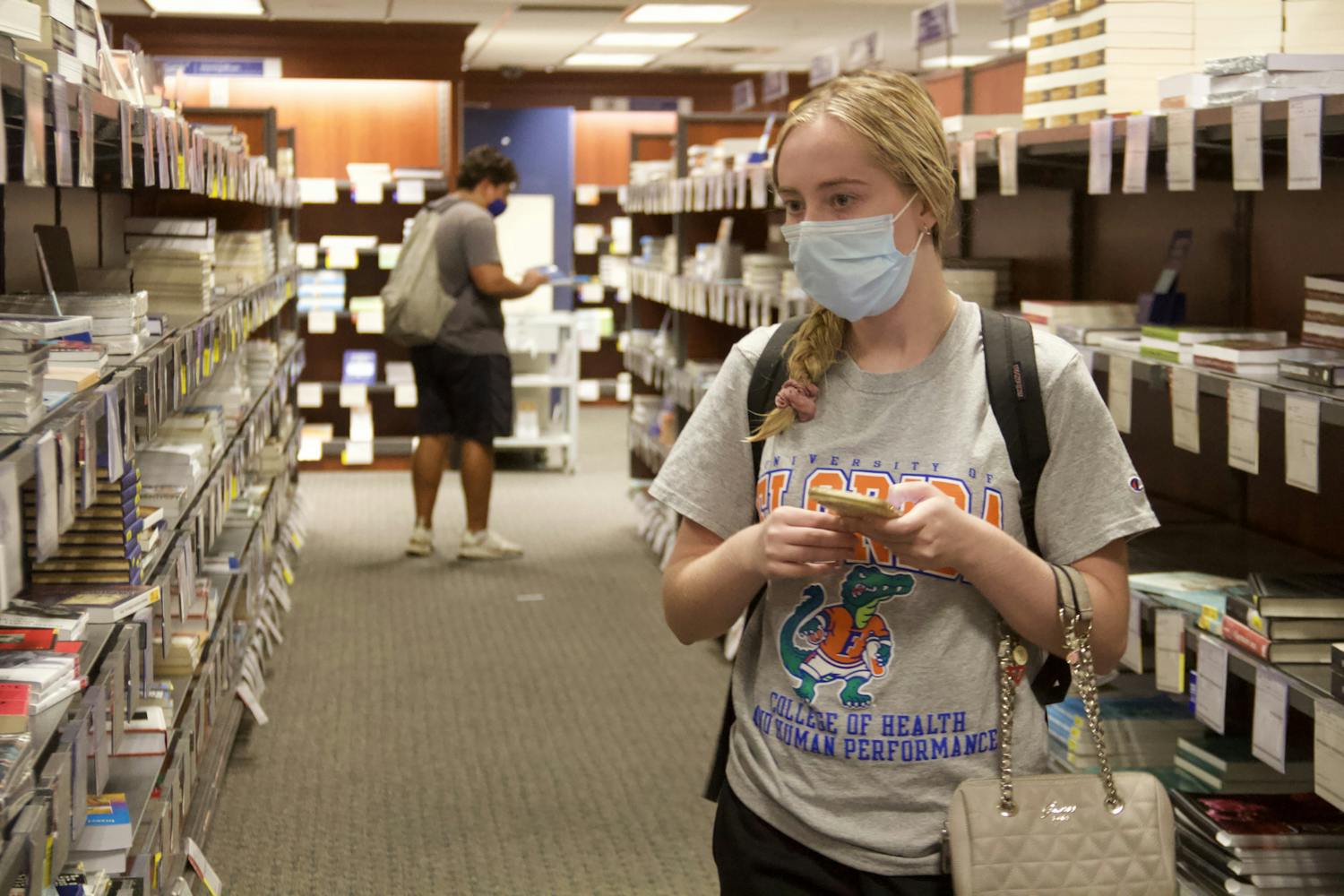 Madison Bastian, UF health education and behavior fourth-year, shops for her textbooks at the UF Bookstore on Wednesday, Sept. 1, 2021. The top-level Bright Futures' stipend, used by many students to buy textbooks, was taken away this semester. "I'm very disappointed," Bastian said. 