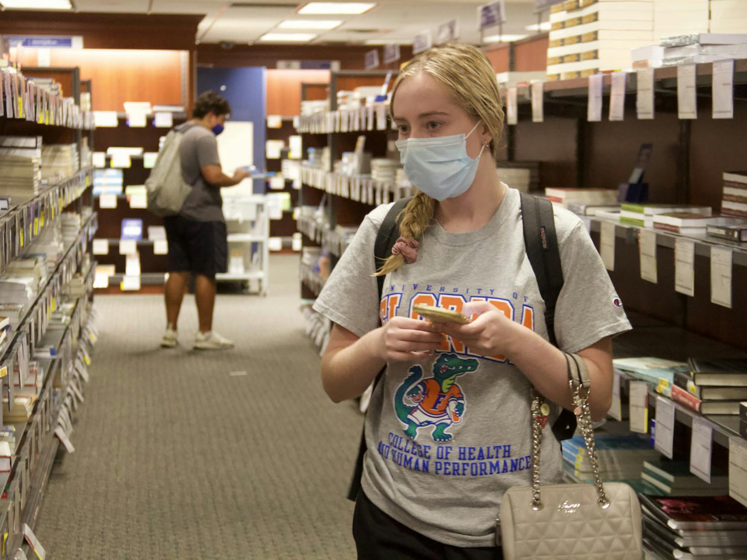 Madison Bastian, UF health education and behavior fourth-year, shops for her textbooks at the UF Bookstore on Wednesday, Sept. 1, 2021. The top-level Bright Futures' stipend, used by many students to buy textbooks, was taken away this semester. "I'm very disappointed," Bastian said.