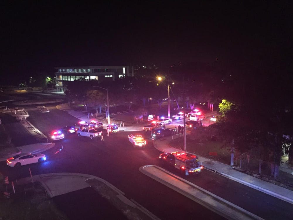 Patrol vehicles from different agencies driving through Gainesville at 1 a.m. Friday along University Avenue to escort the deputies to the medical examiner's office on Southwest Third Avenue. 