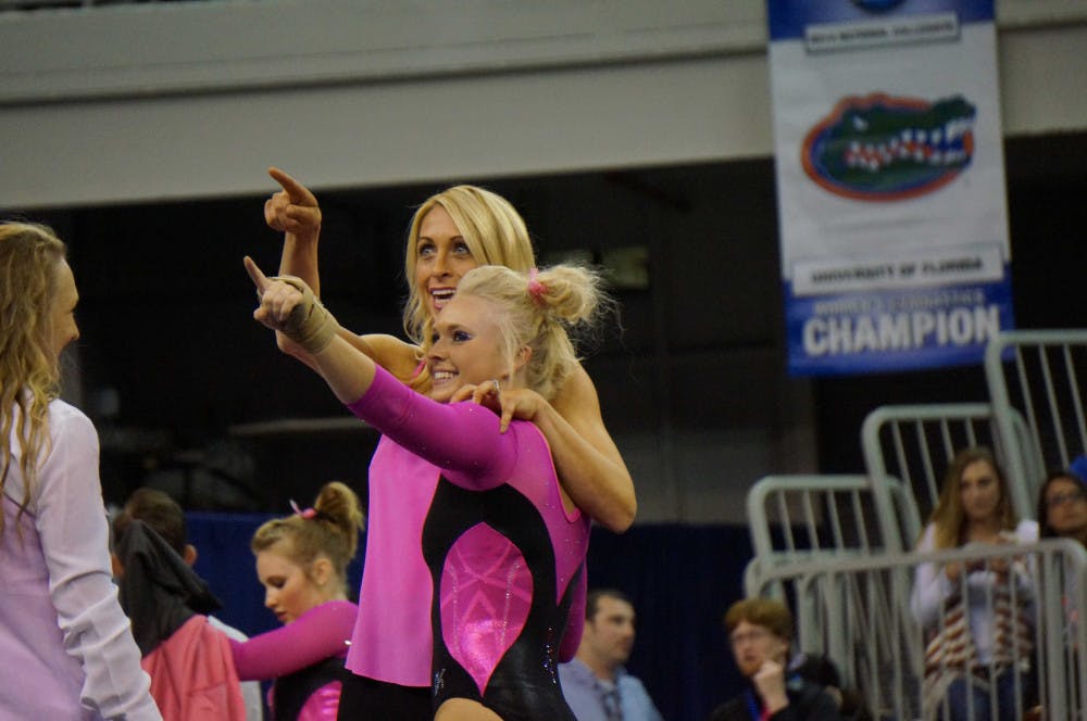 Rachel Spicer and coach Rhonda Faehn point to Spicer's mom in the O'Connell Center crowd during Florida's win against Kentucky on Feb. 27
