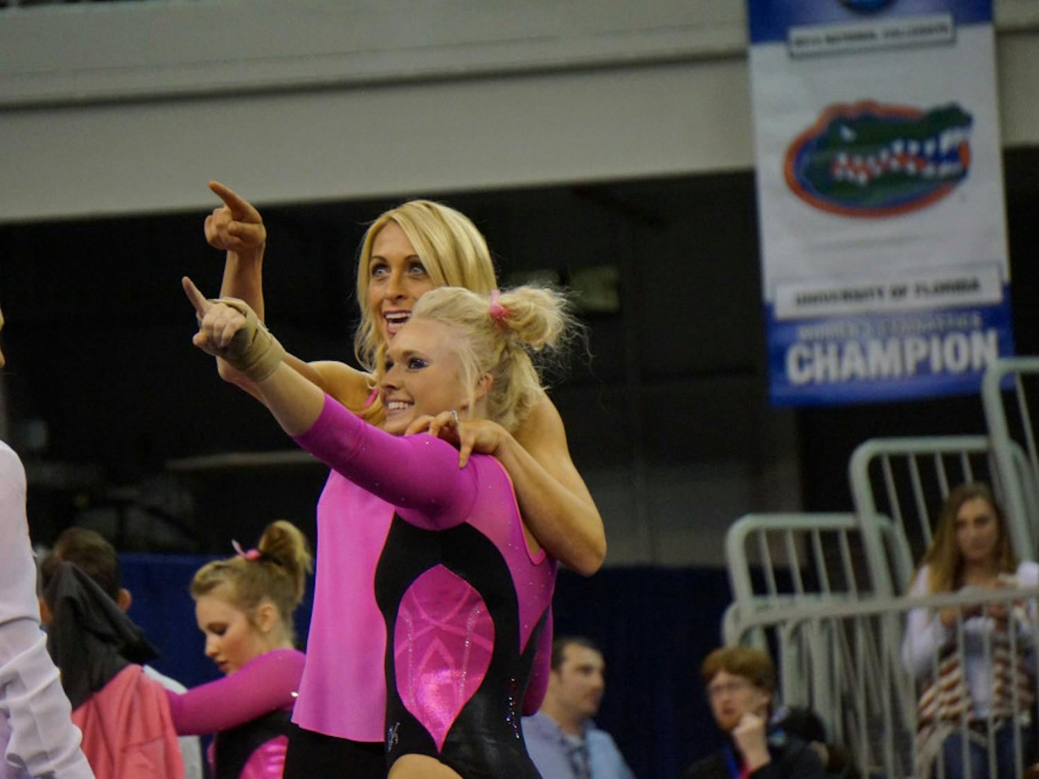 Rachel Spicer and coach Rhonda Faehn point to Spicer's mom in the O'Connell Center crowd during Florida's win against Kentucky on Feb. 27