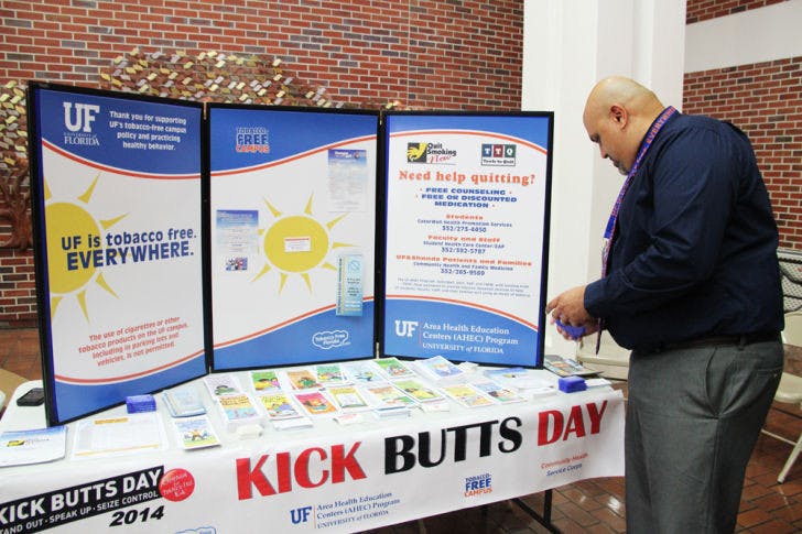 Syraj Syed, a coordinator for education and training programs, provides resources about the dangers of smoking in the UF Health Shands Hospital atrium Wednesday.