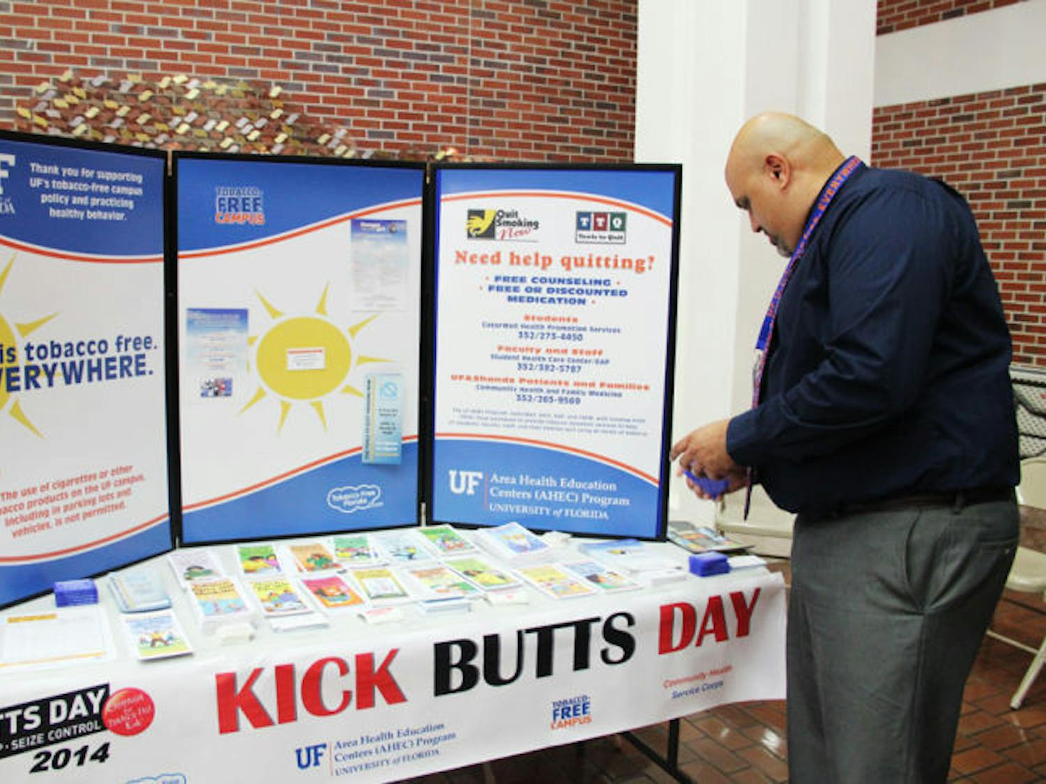 Syraj Syed, a coordinator for education and training programs, provides resources about the dangers of smoking in the UF Health Shands Hospital atrium Wednesday.