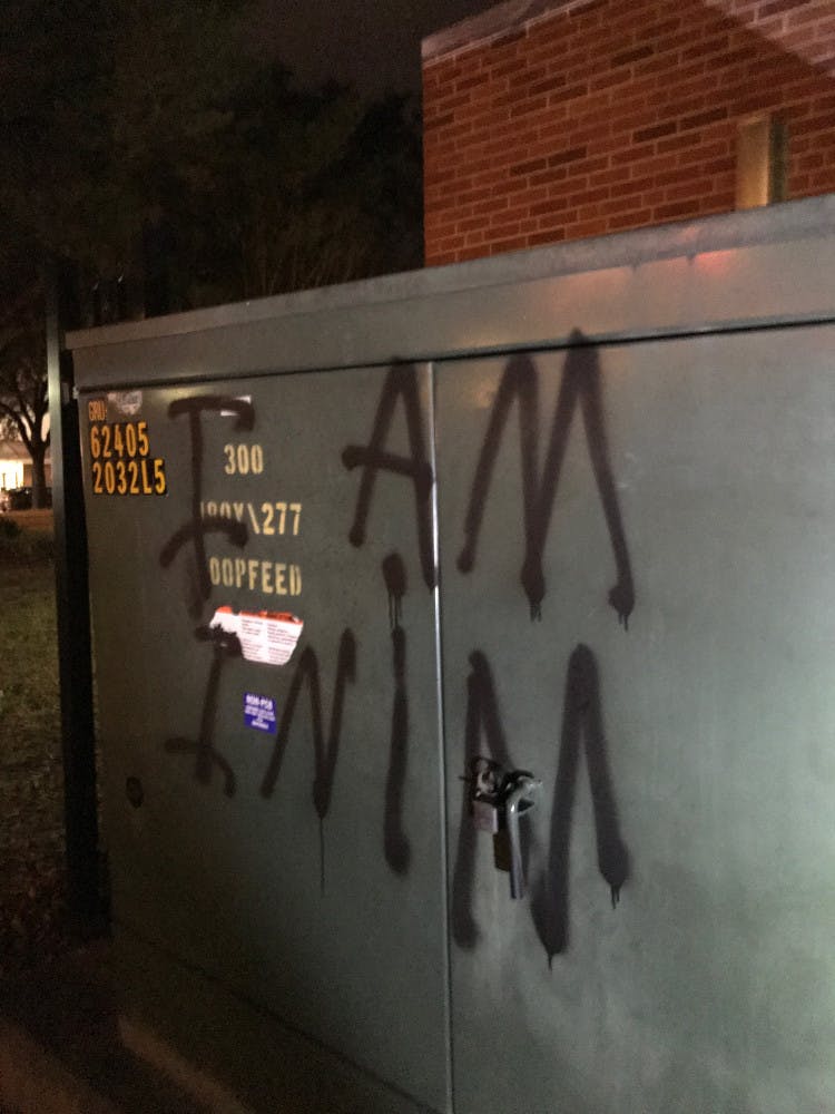 A UF student spray-painted "I AM INIM" onto the wall of an Alachua County building downtown early Wednesday.