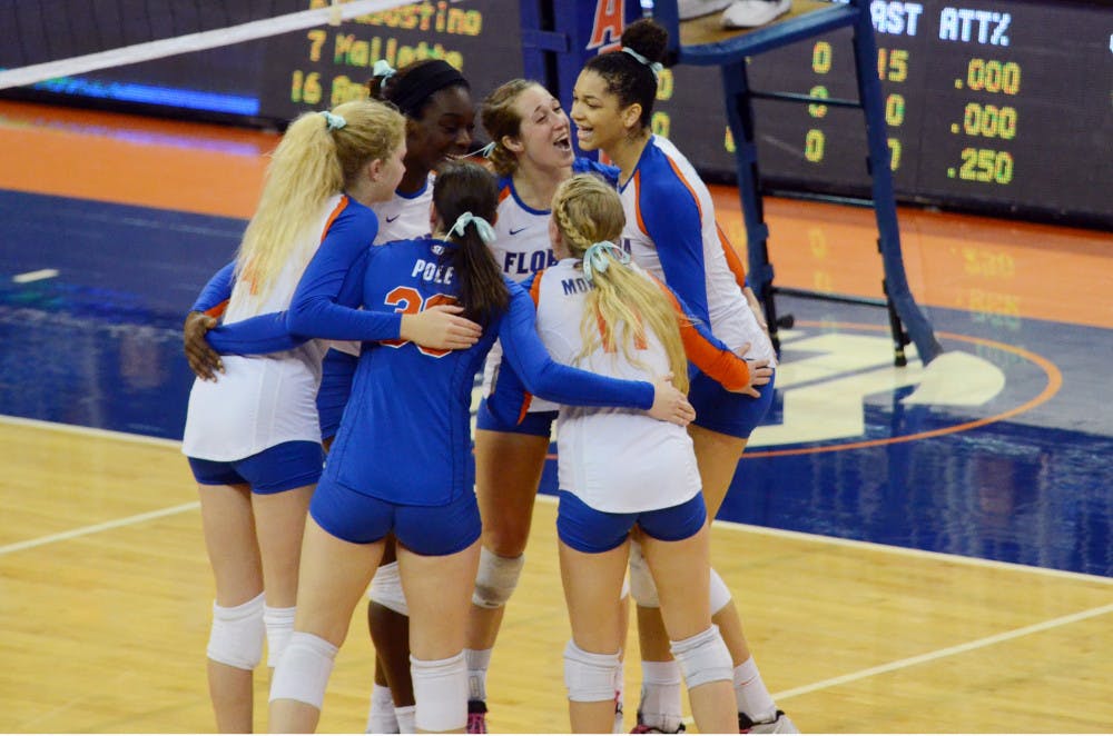 UF players celebrate during No. 8 seed Florida's 3-1 win against Miami in the second round of the NCAA Tournament on Saturday in the O'Connell Center.