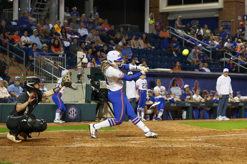 Catcher Emily Wilkie hits the ball in an 11-0 victory against the Jacksonville Dolphins Wednesday, Feb. 15, 2023. 