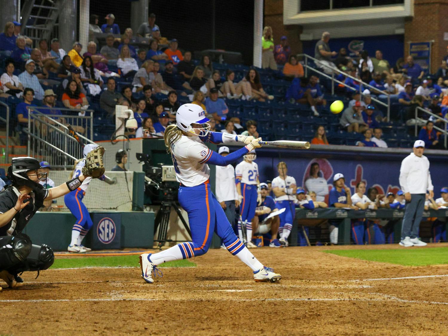 Catcher Emily Wilkie hits the ball in an 11-0 victory against the Jacksonville Dolphins Wednesday, Feb. 15, 2023.