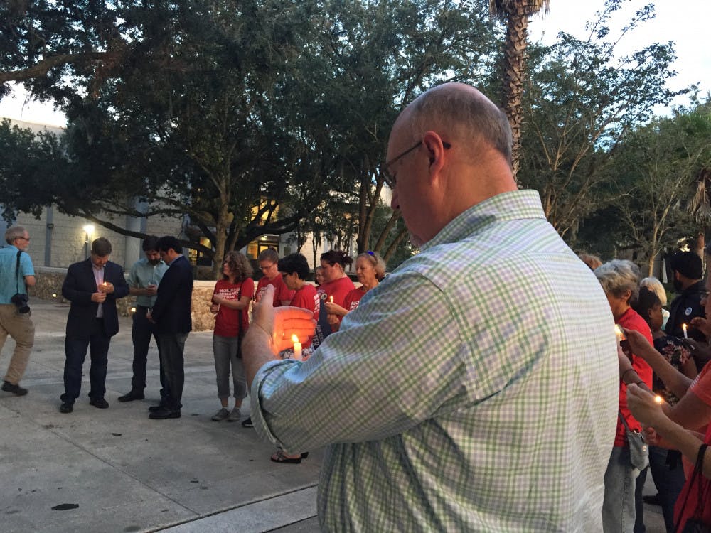 About 50 Gainesville residents and elected officials gathered to honor the victims of Sunday's mass shooting in Jacksonville