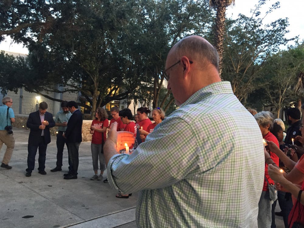 <p>About 50 Gainesville residents and elected officials gathered to honor the victims of Sunday's mass shooting in Jacksonville</p>