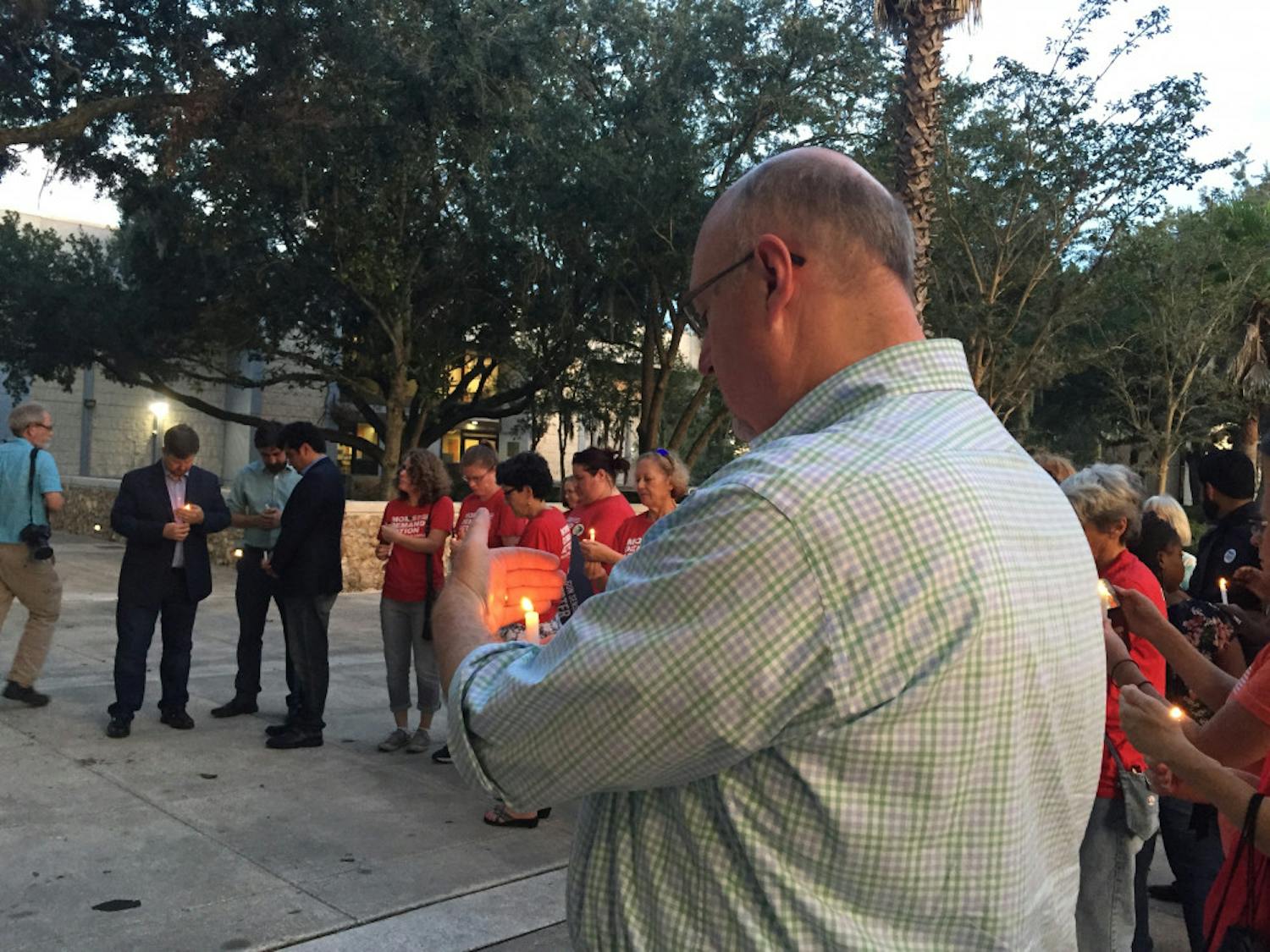 About 50 Gainesville residents and elected officials gathered to honor the victims of Sunday's mass shooting in Jacksonville